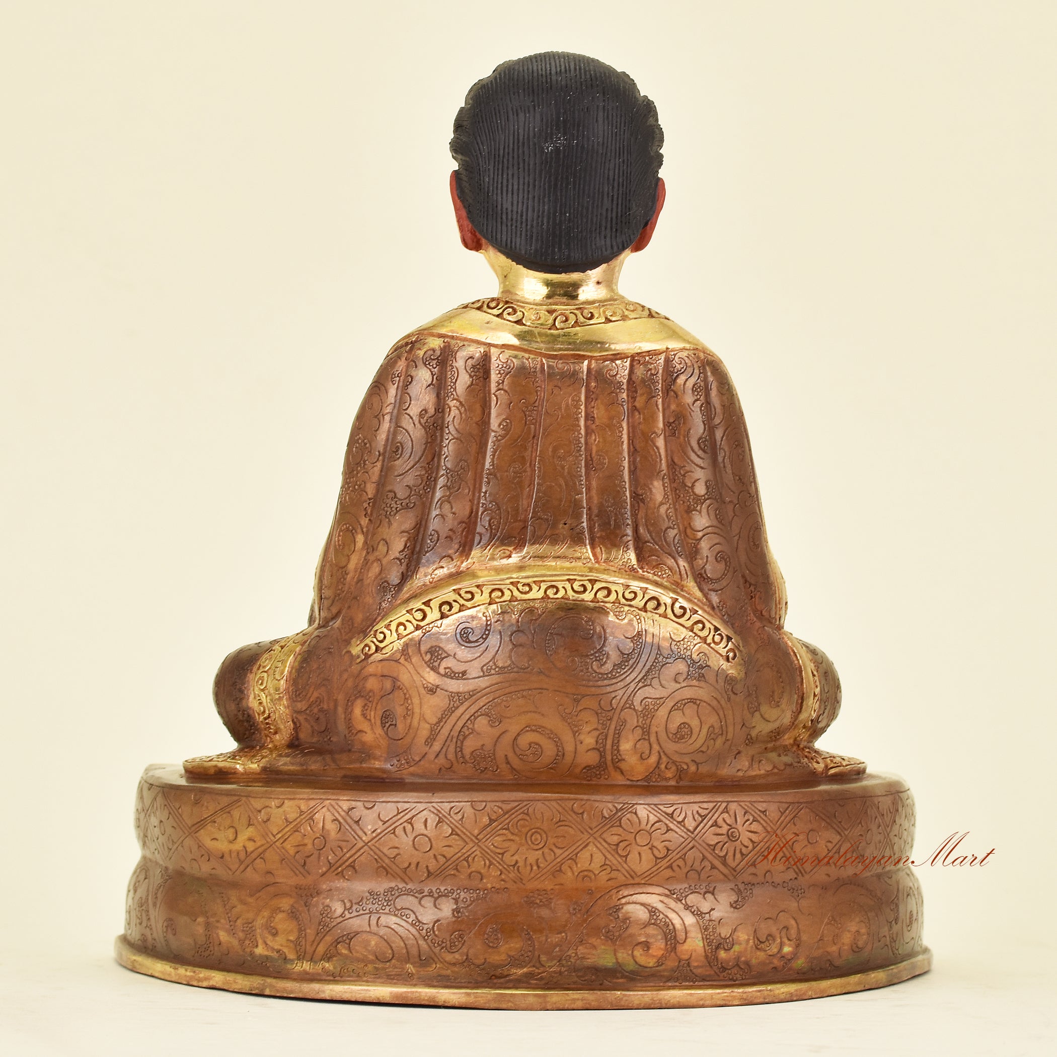 Back view of Tibetan Guru Marpa Statue showing traditional robes of a Kagyu lineage master