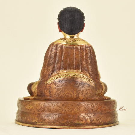 Back view of Tibetan Guru Marpa Statue showing traditional robes of a Kagyu lineage master