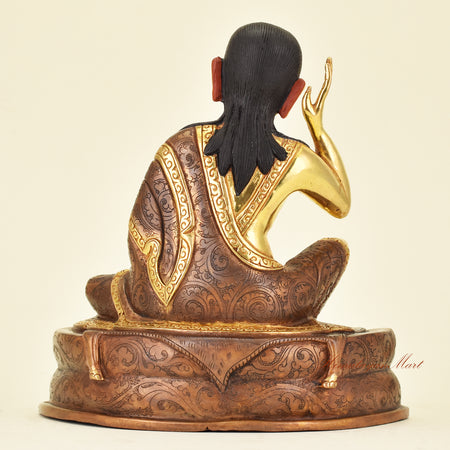 Back view of Tibetan Guru Milarepa Statue showing robes of a legendary Tibetan yogi and saint