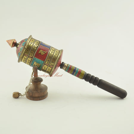Tibetan Handheld Prayer Wheel shown from the left side – spiritual tool for mantra recitation and mindfulness