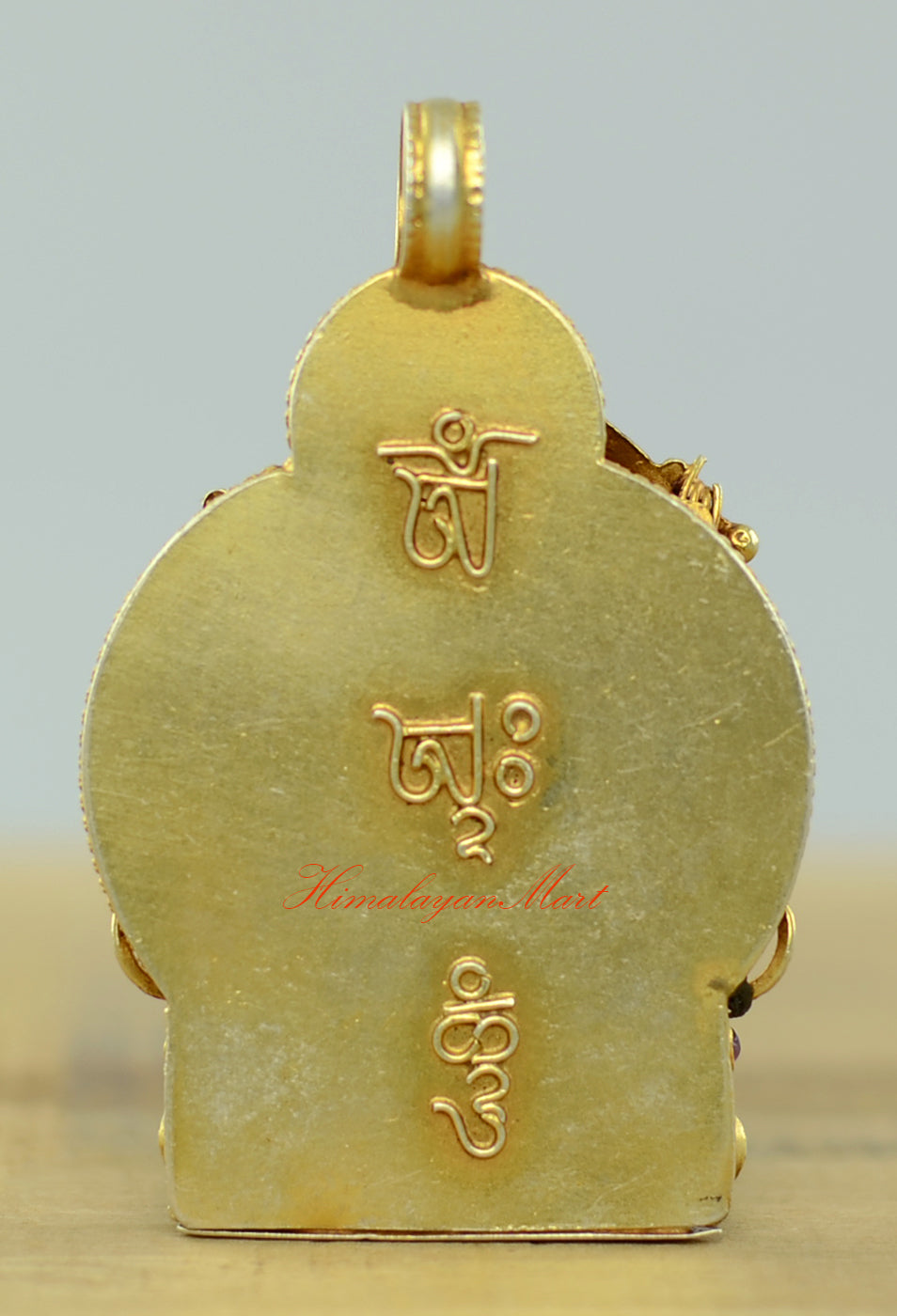 Back view of the Tibetan Manjushri Locket showing detailed hand-carved filigree and silver craftsmanship.