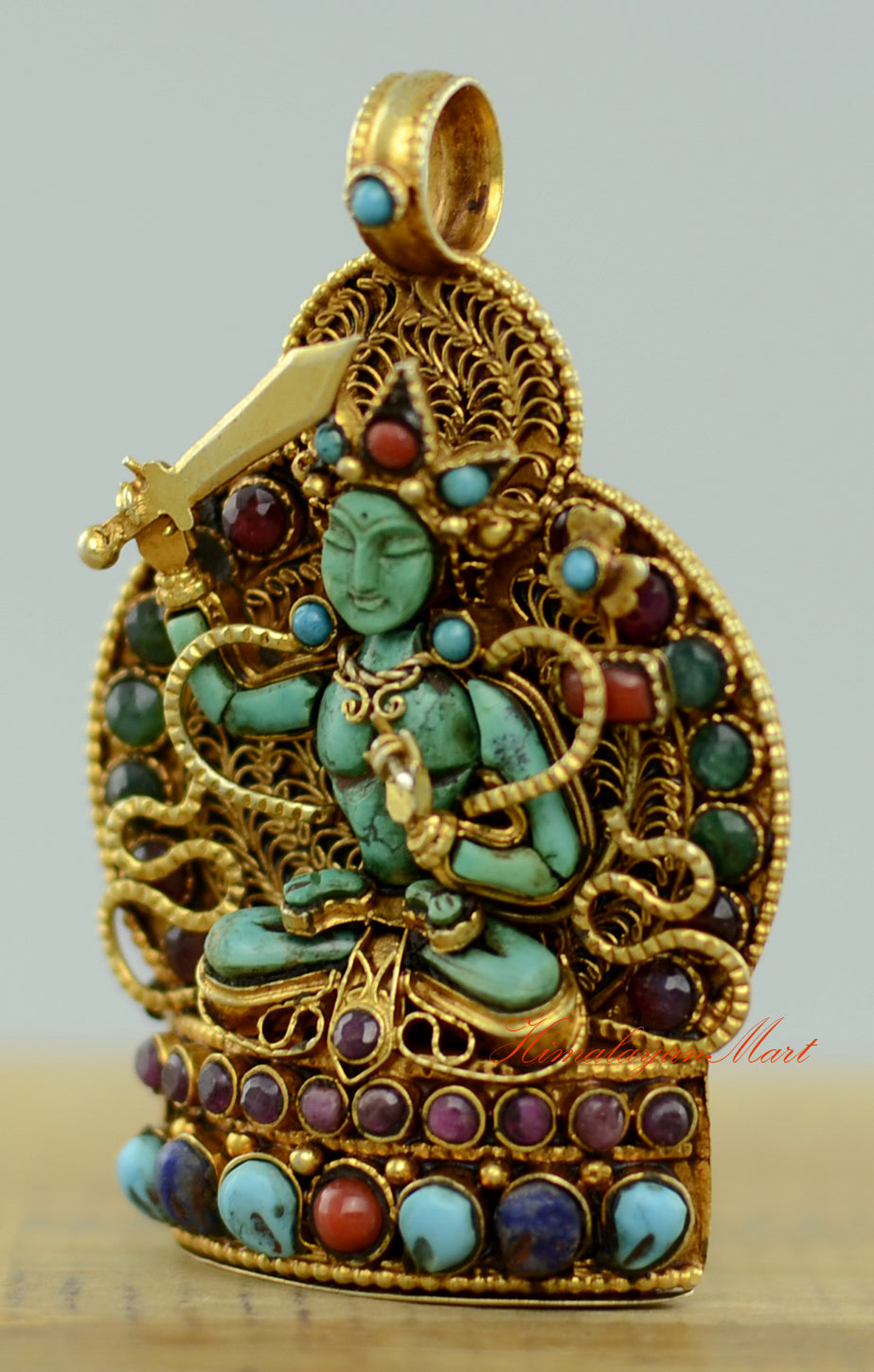 Left-side view of the Tibetan Manjushri Locket showing precise stone settings and intricate filigree.