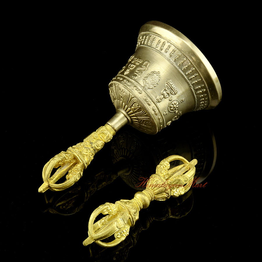 Left side view of copper and bronze meditation bell and Vajra, showing the antique-style patina and yellow handle detail