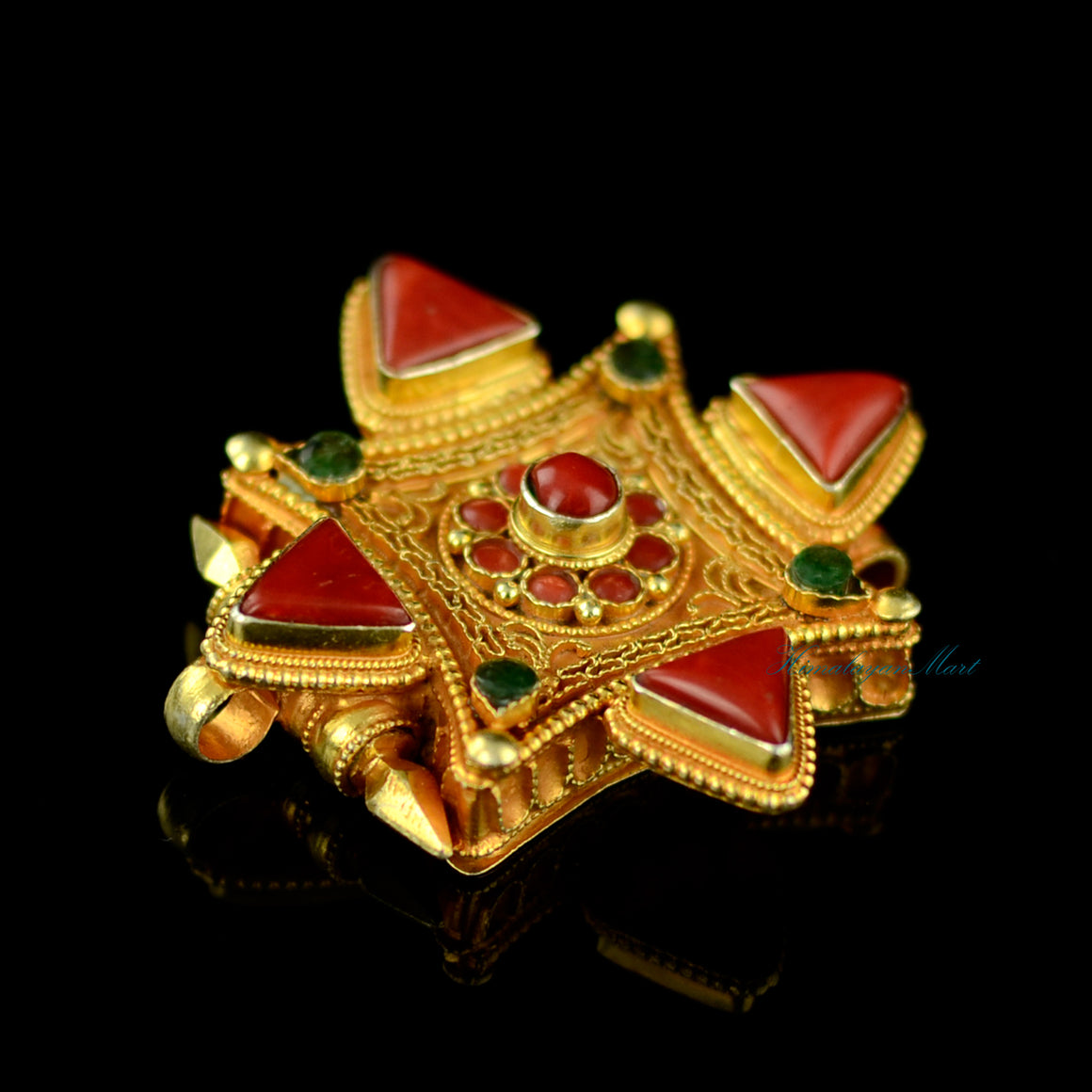 Left-side angle of handcrafted Tibetan pendant jewelry featuring intricate silver filigree and gemstone settings.