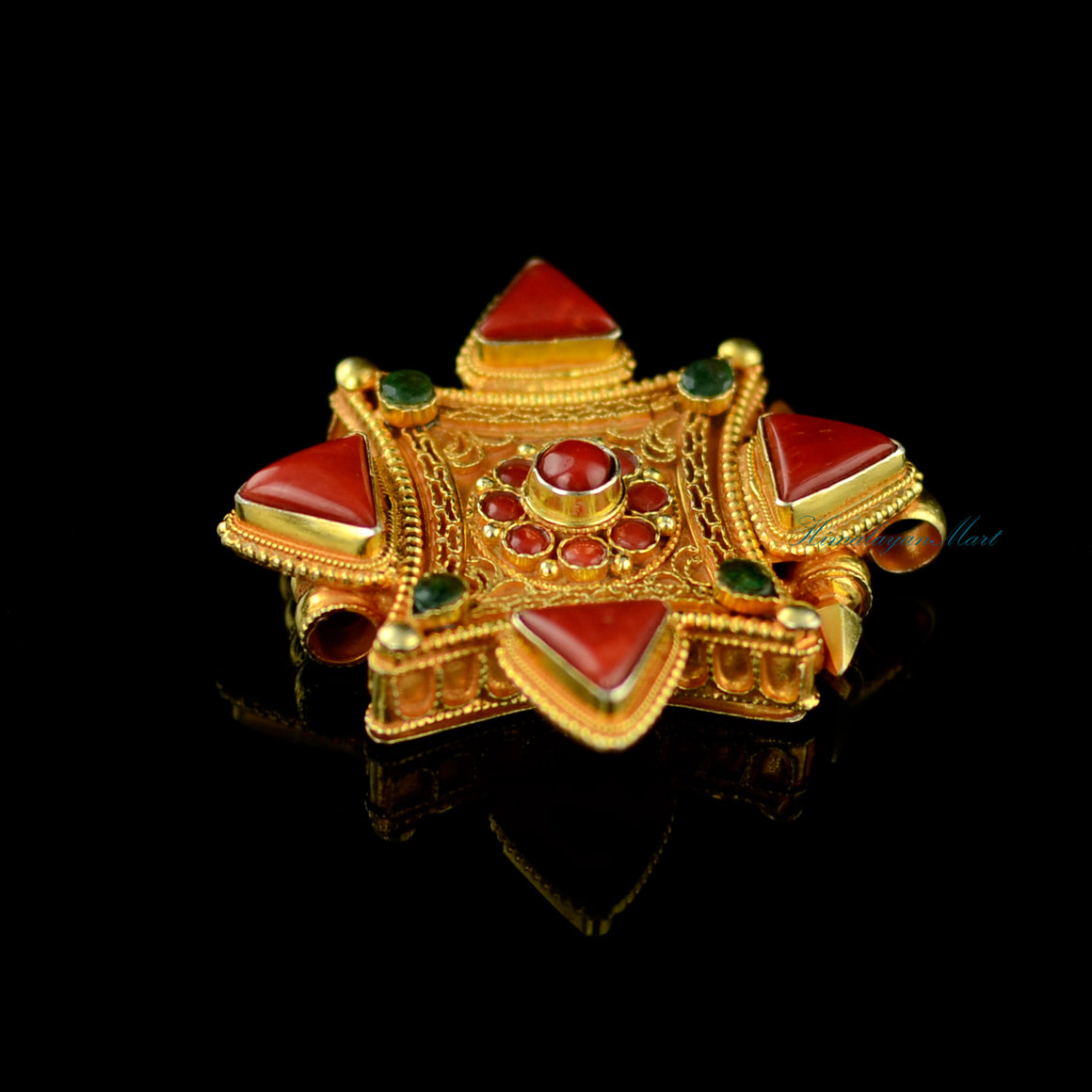 Right-side view of Tibetan pendant jewelry showcasing silver siko filigree and coral and emerald inlays.
