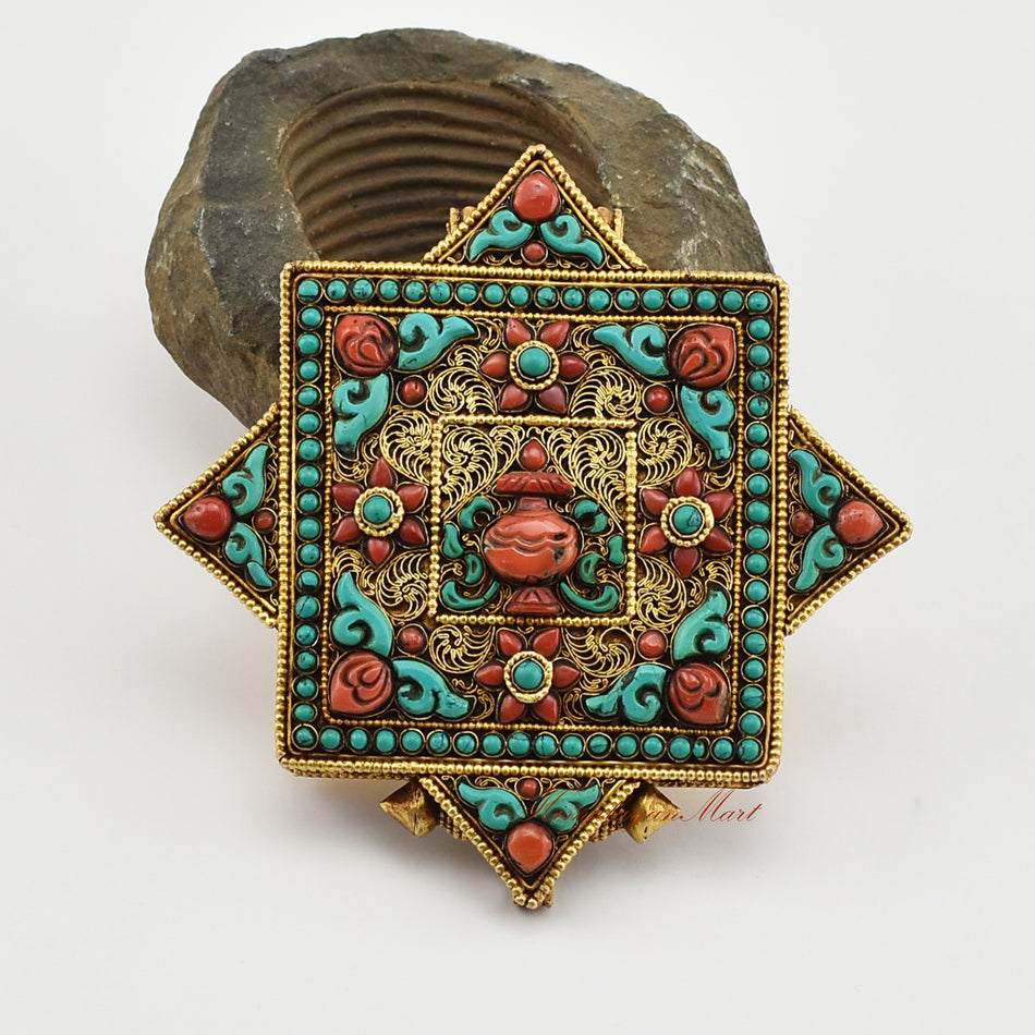 Front view of a Tibetan Religious Prayer Box Pendant, a sacred Buddhist amulet adorned with coral and turquoise stones.