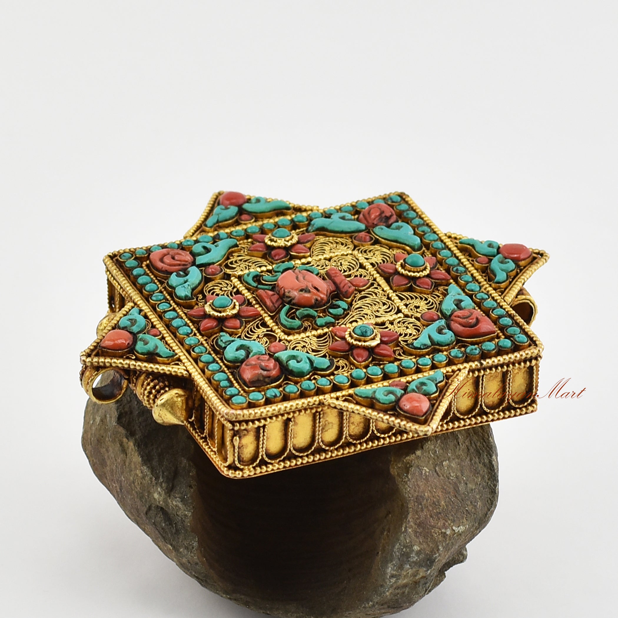 Side view of the Tibetan Religious Prayer Box Pendant highlighting intricate Siko filigree and coral Kalasha centerpiece.