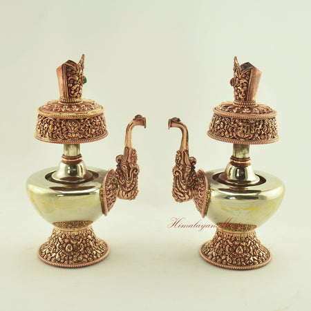 Two Tibetan Ritual Bhumba Set vases displayed together, handcrafted from copper and white metal with coral and turquoise inlay.