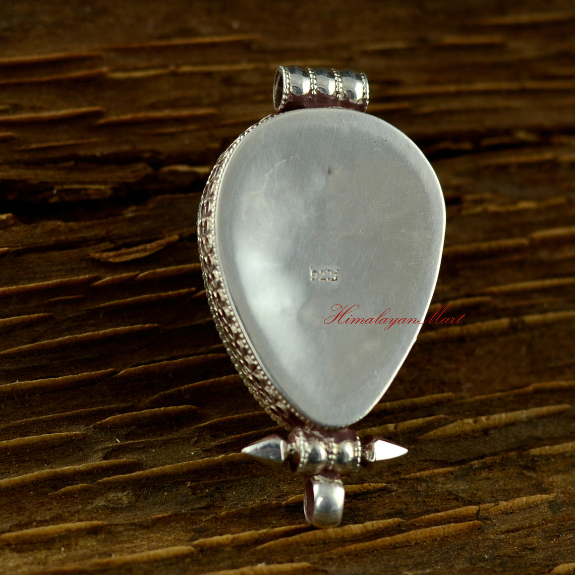 Back view of the handmade turquoise silver pendant showing fine silver detailing.