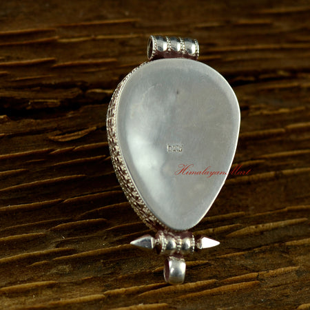 Back view of the handmade turquoise silver pendant showing fine silver detailing.