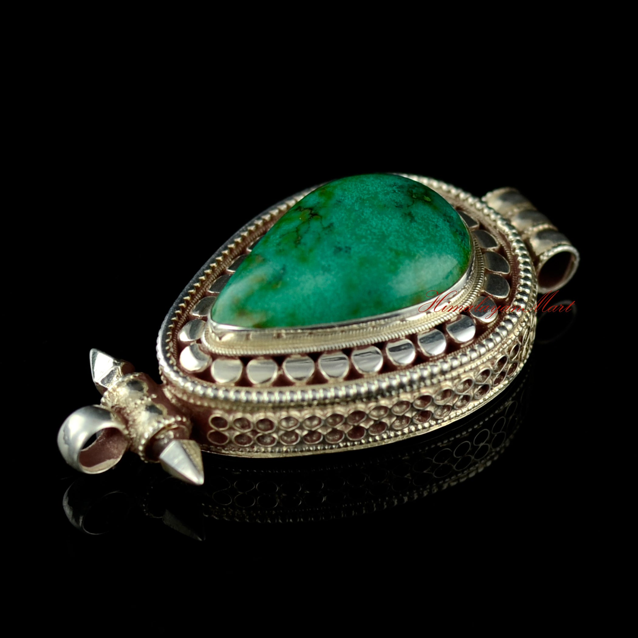 Left-side view of the turquoise silver pendant highlighting craftsmanship and gemstone setting.