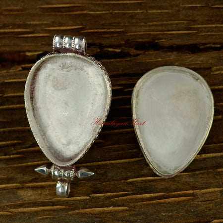 Opened view of the turquoise silver pendant showing interior space and intricate craftsmanship.