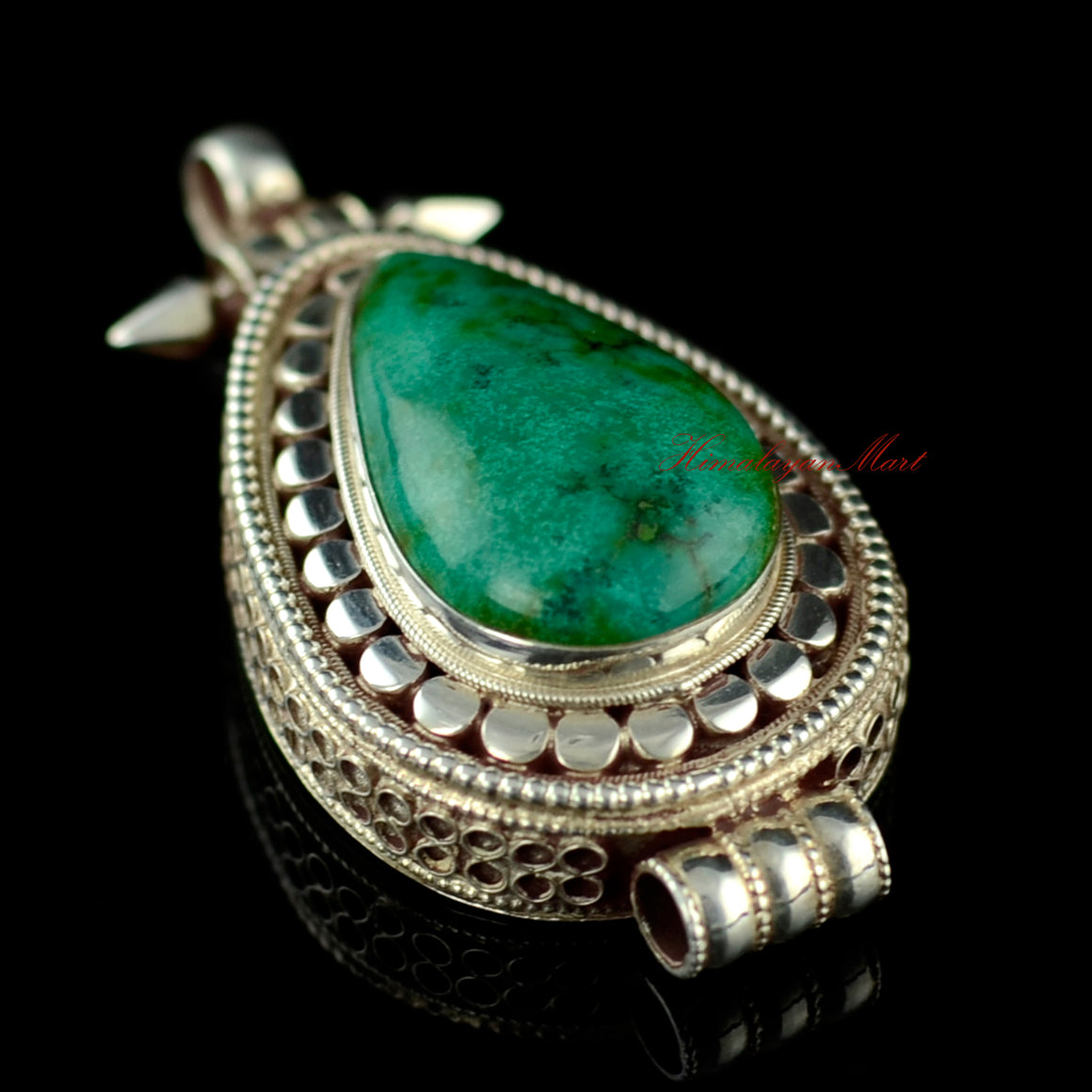 Right-side view of the handmade turquoise silver pendant showcasing detailed filigree work.