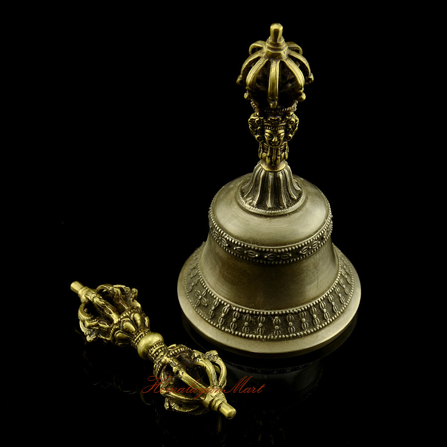 Vajra Bell Meditation Set side view showing antique copper and bronze finish, intricately engraved Tibetan Buddhist motifs, handmade by Newar artisans in Patan Nepal