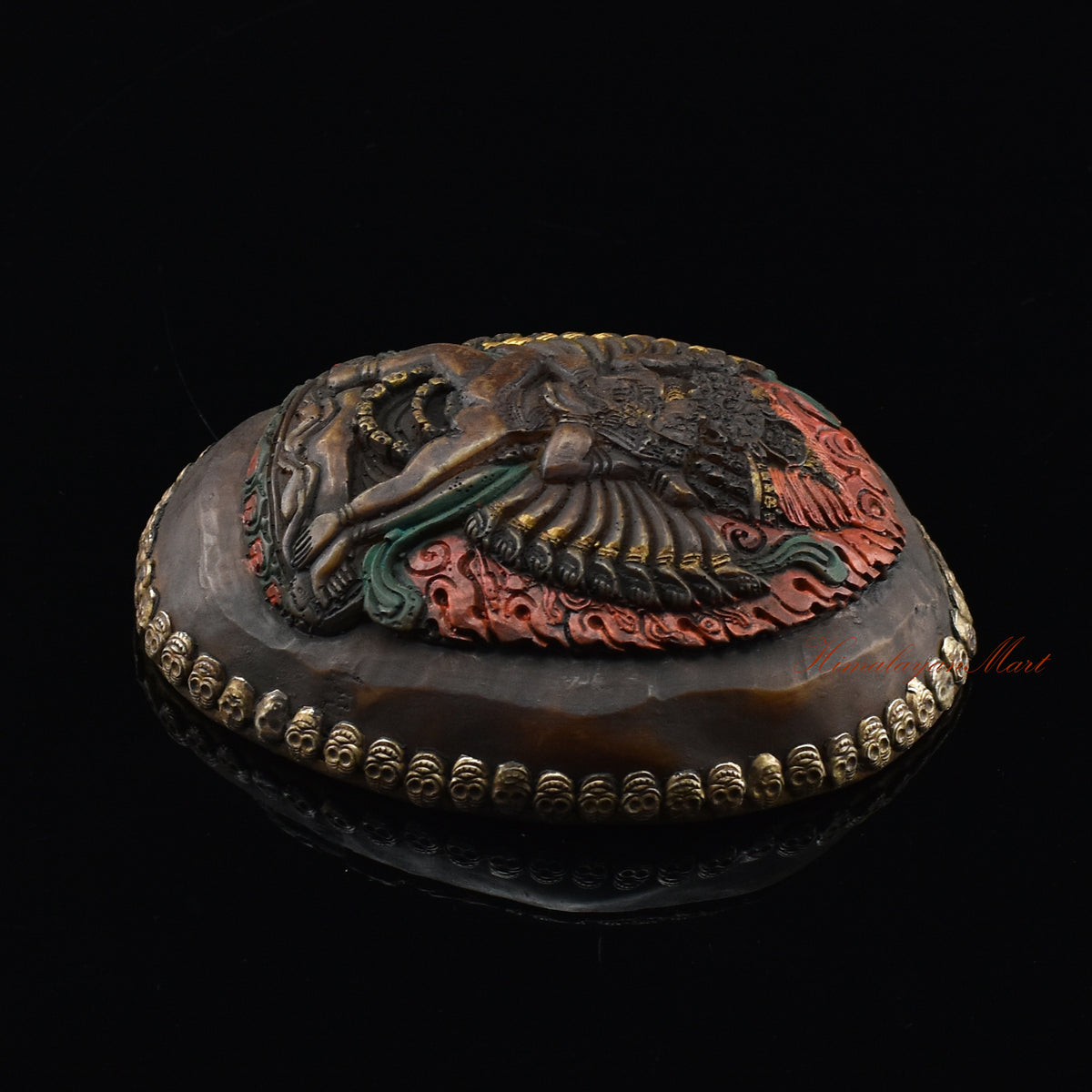 Right side view of the Vajrabhairava Carved Resin Kapala showing silver-plated copper detailing and skull motifs