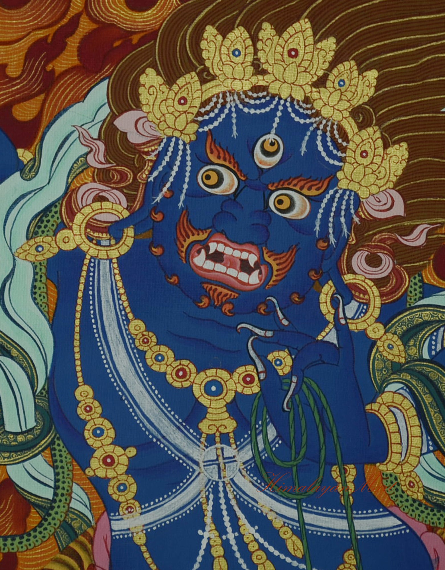 Close-up of Vajrapani's wrathful face, painted with fierce expression and golden highlights.