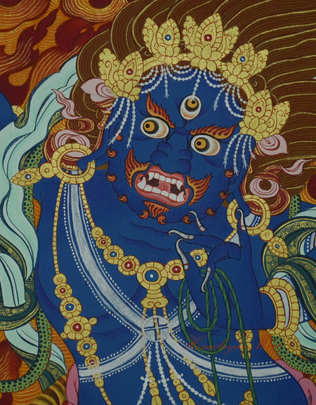 Close-up of Vajrapani's wrathful face, painted with fierce expression and golden highlights.