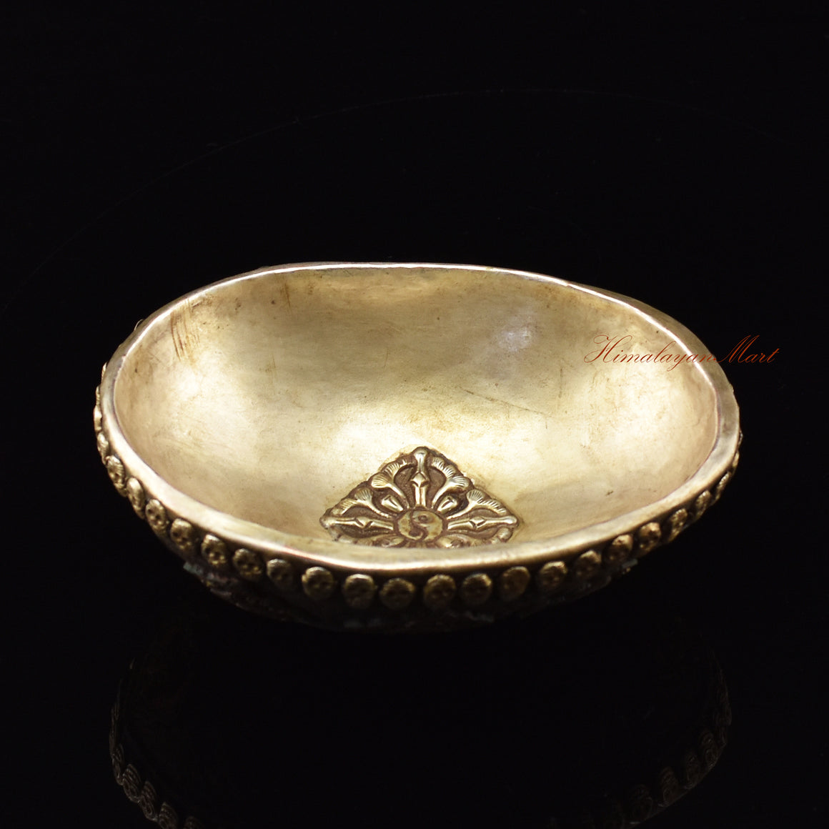 Angled perspective view of the Vishvavajra Ashtamangala Resin Kapala showing full ornate design