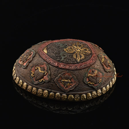 Right side view of the Vishvavajra Ashtamangala Resin Kapala showing silver-plated copper detailing