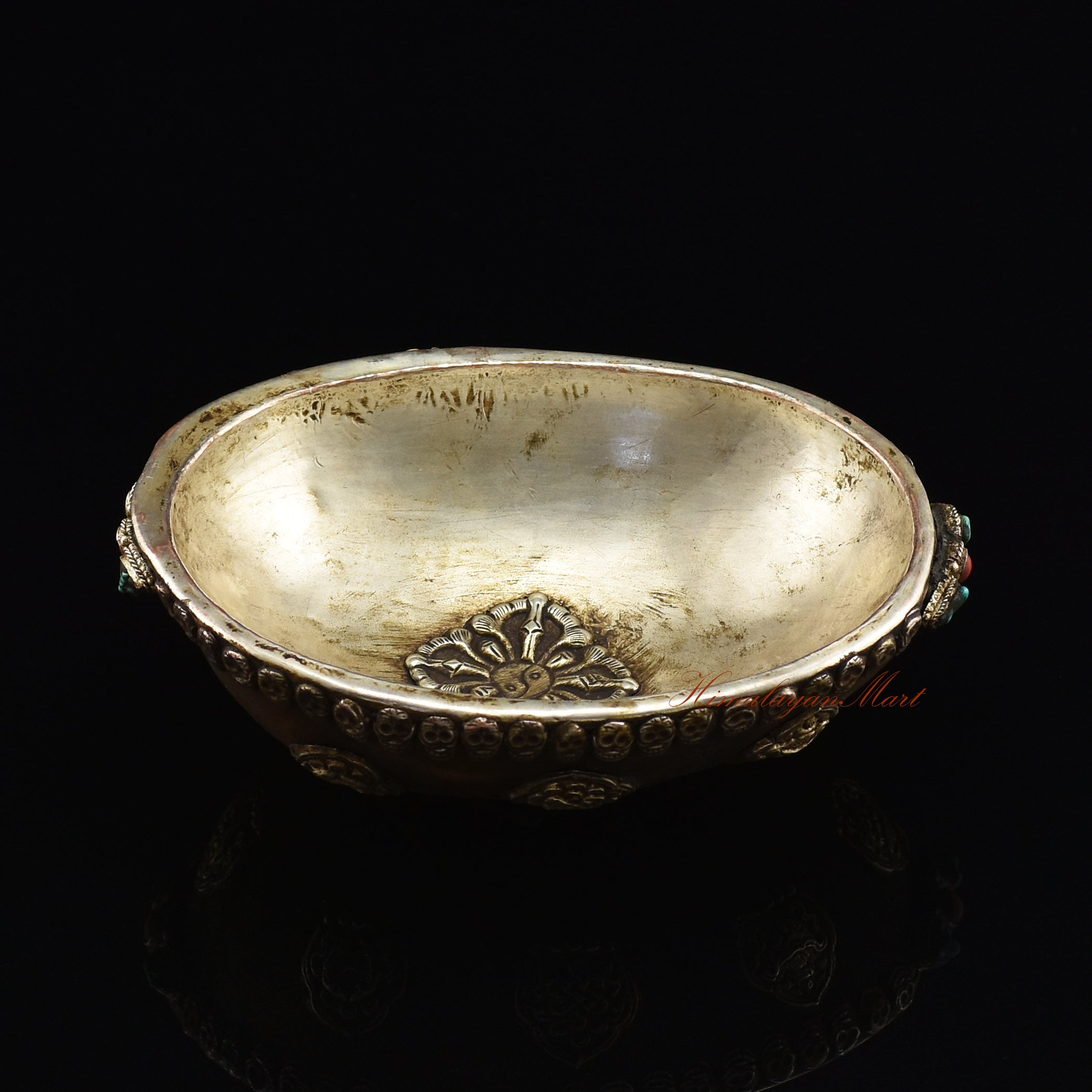 Angled top view of the Viswa Vajra Resin Kapala capturing the full centerpiece and skull-border detailing