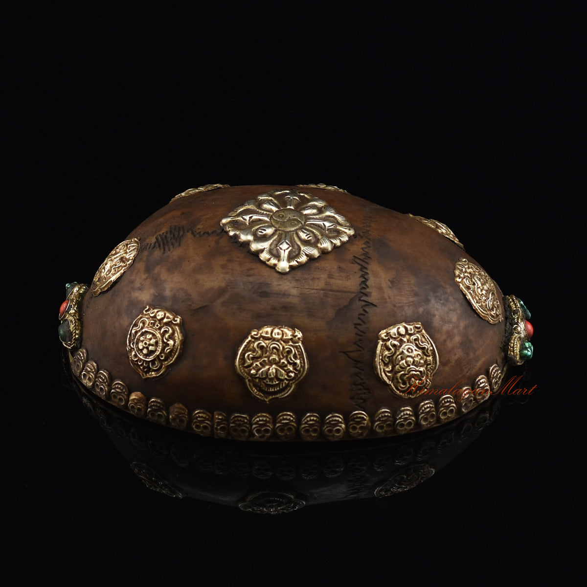 Left side view of the Viswa Vajra Resin Kapala highlighting the silver-plated copper accents