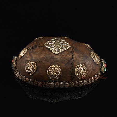 Left side view of the Viswa Vajra Resin Kapala highlighting the silver-plated copper accents
