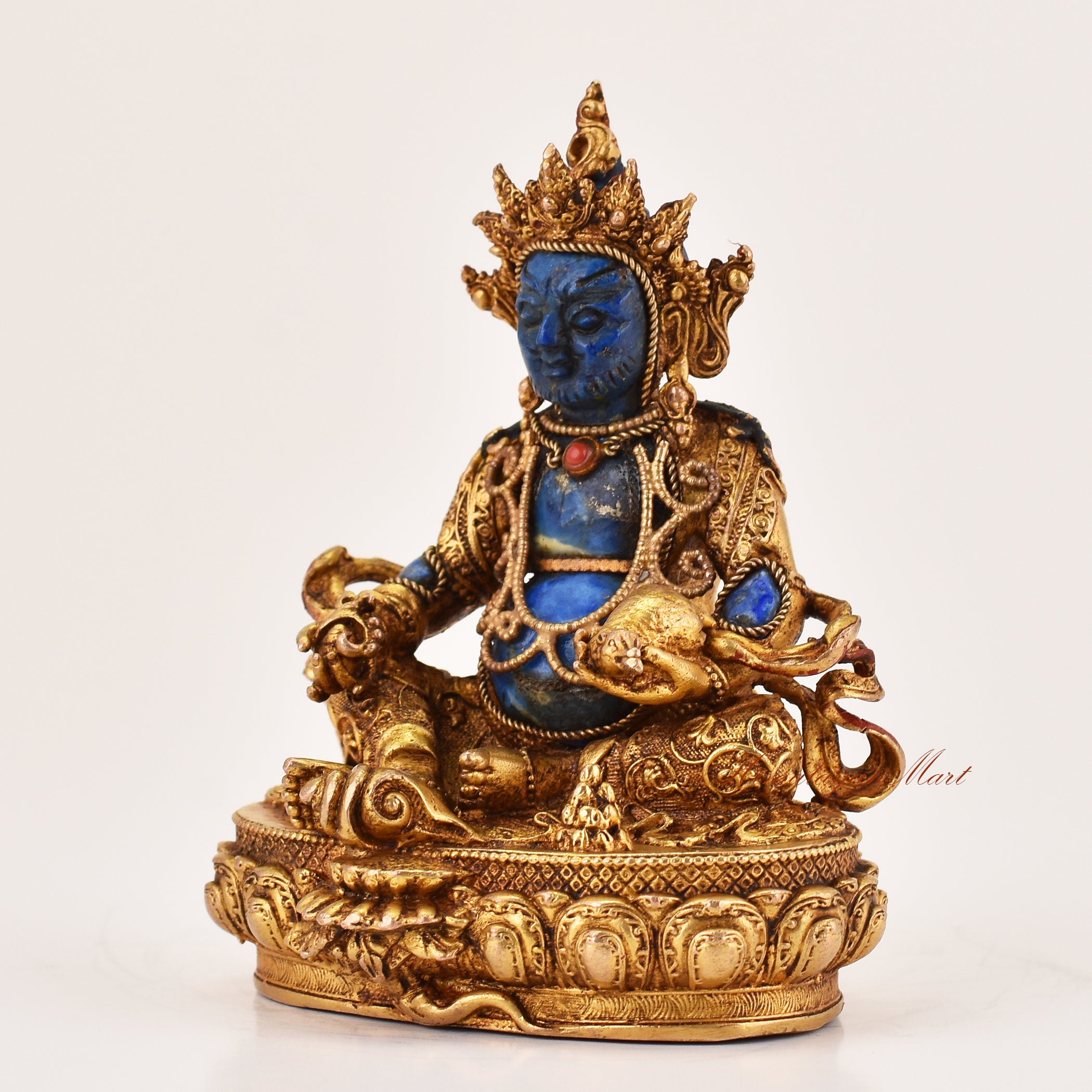 Left side profile of Yellow Dzambhala lapis statue showing detailed Tibetan Buddhist craftsmanship and symbolic wealth attributes.